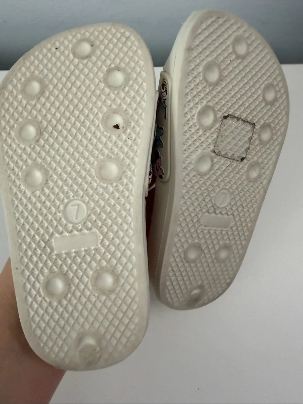 white slides feature a colorful Minnie Mouse and Daisy Duck character size 7t